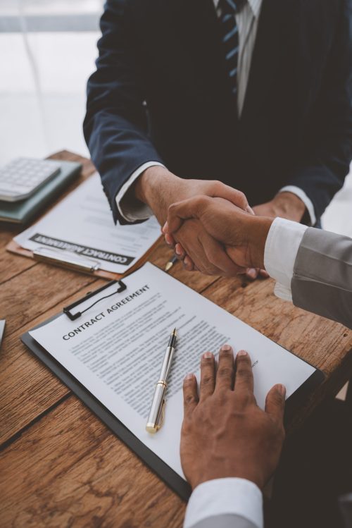 Handshake of real estate brokers with customers or investors, mo Handshake of real estate brokers with customers or investors, mortgage loan agreements Make a lease-purchase-sell house and home insurance mortgage loan concept.